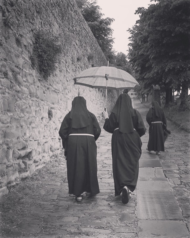 Three nuns climbing the Via Santa Margherita in Cortona.