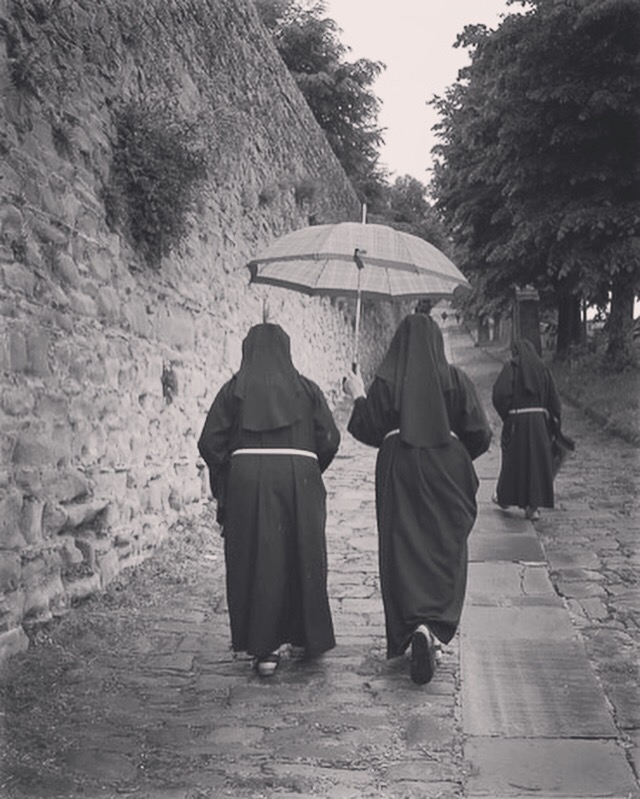 Three nuns climbing the Via Santa Margherita  in Cortona. 